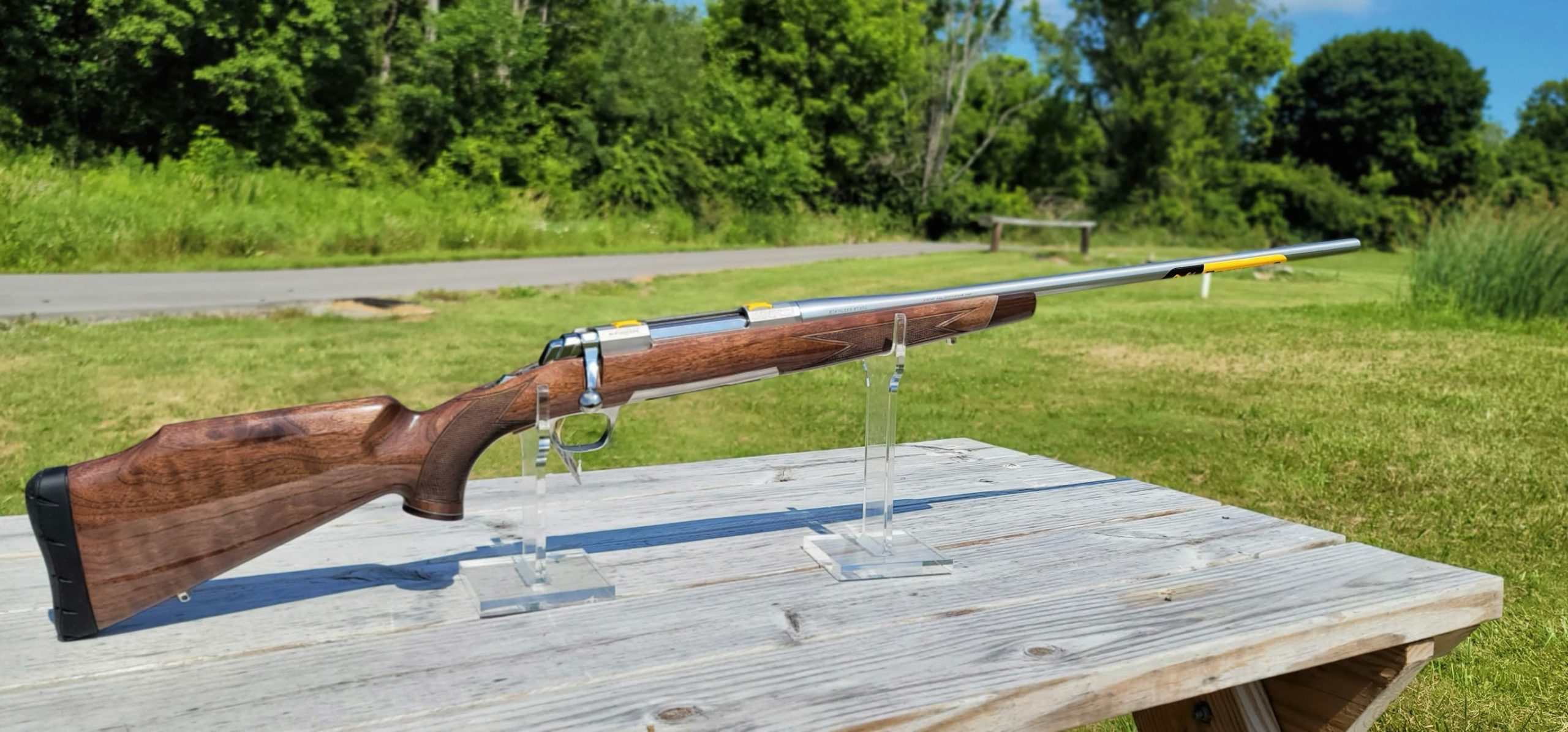 Browning X-Bolt White Gold rifle with walnut stock and polished stainless steel barrel.