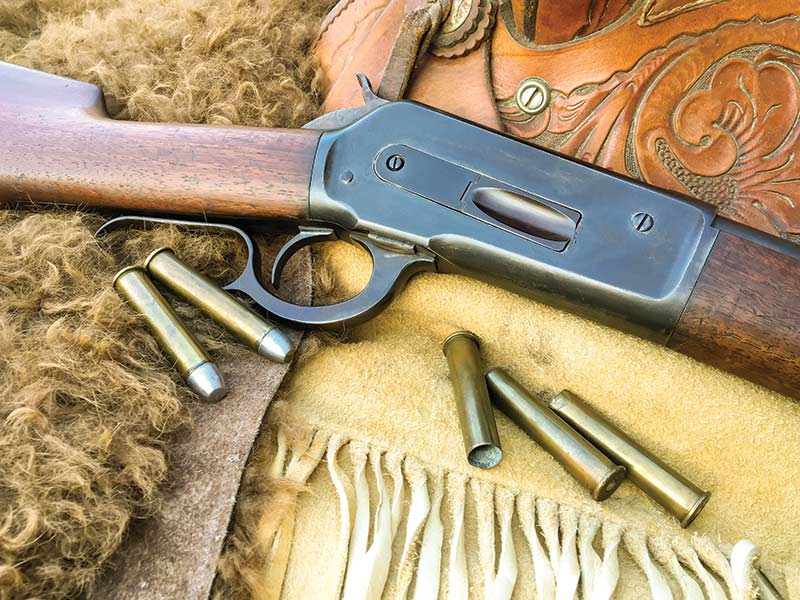 Winchester Model 1886 Short Rifle with a walnut stock and blued steel finish.