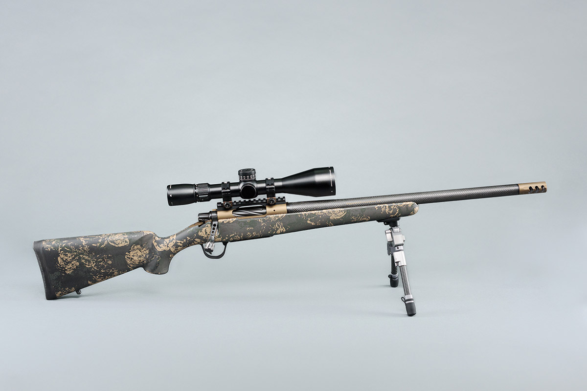 Christensen Arms Ridgeline hunting rifle with carbon fiber barrel and green spiderweb stock.