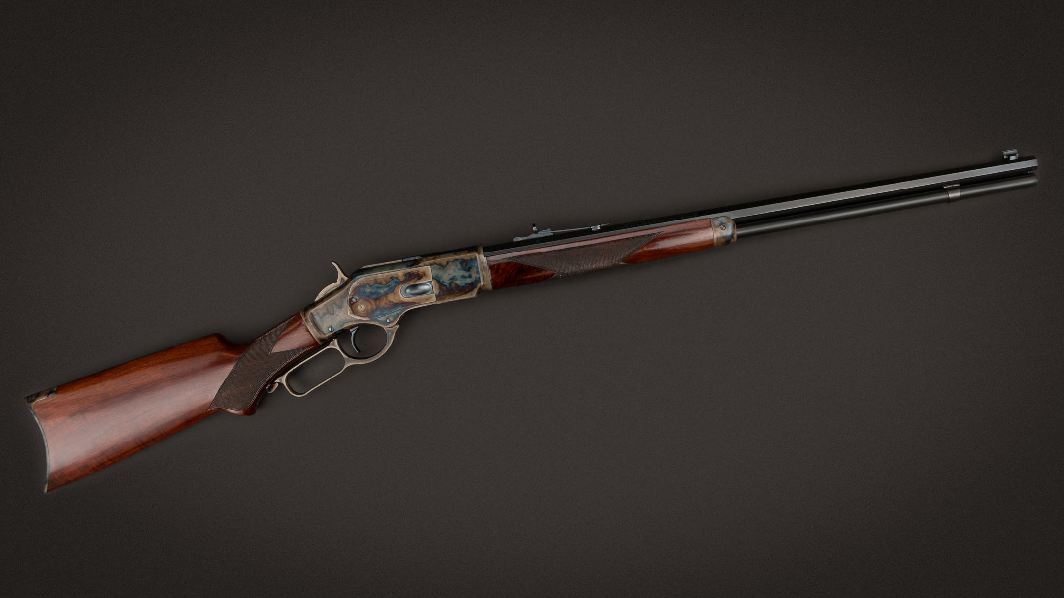 Winchester Model 1873 Lever-Action Rifle with walnut stock and blued barrel